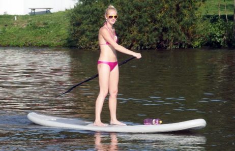 Woman Stands at Paddle Board Woman Stands at Paddle Board