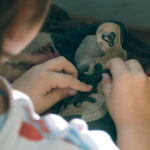 Free photo: Boy trying to tie his shoes