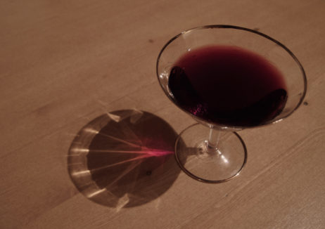 Glass of red wine on a wooden table Glass of red wine on a wooden table