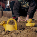Young boy in the sandbox | Free stock photo