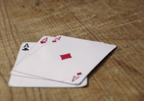 Three Aces Cards On Wooden Table Three Aces Cards On Wooden Table