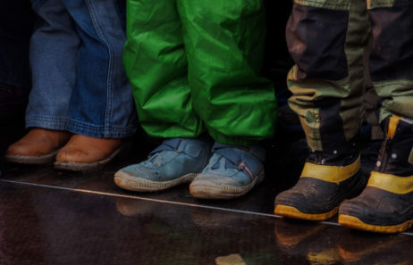 Three children standing – shoes and feet Three children standing – shoes and feet