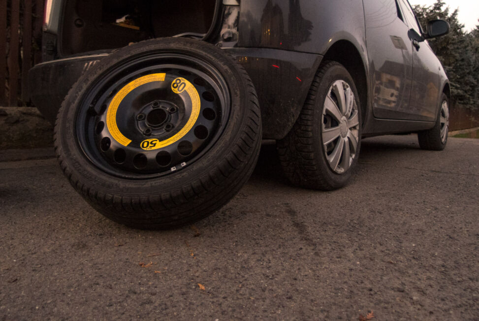 The spare tire leaning against a black car Copyrightfree photo (by M