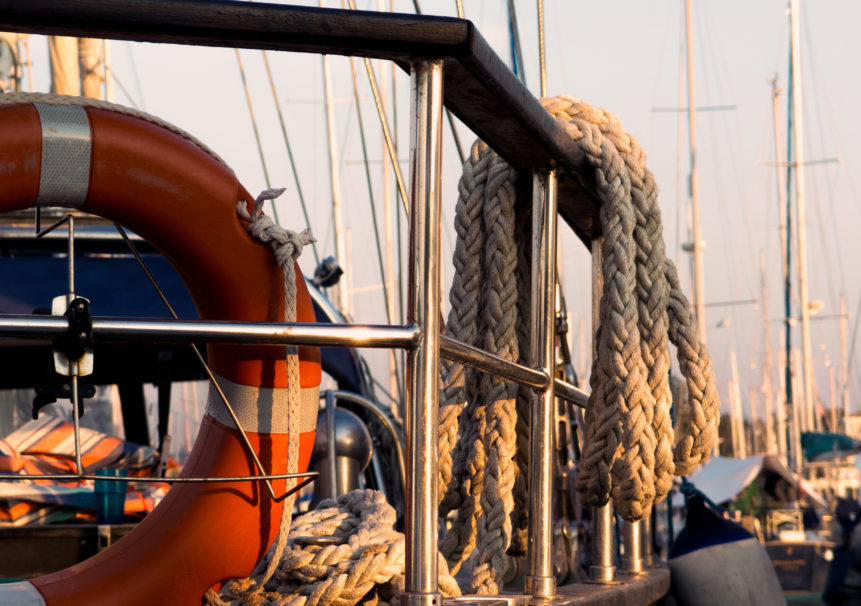 Railing, rope and lifebuoy on yacht | Free Stock Photo
