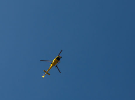 Yellow helicopter against the blue sky Yellow helicopter against the blue sky