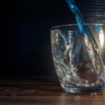 Water is poured into the glass Image of water poured into the glass