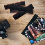 Camera Film And Photos On Wooden Background Camera Film And Photos On Wooden Background