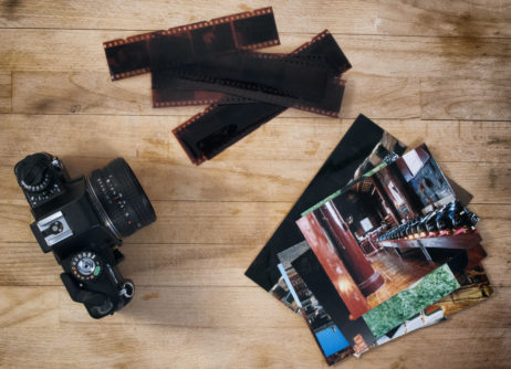 Camera Film And Photos On Wooden Background Camera Film And Photos On Wooden Background