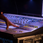 Soundman Behind a Mixer At Concert