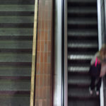 Woman On Moving Staircase Woman On Moving Staircase