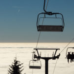 Skiers On A Chairlift Skiers On A Chairlift