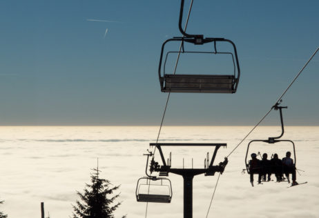 Skiers On A Chairlift Skiers On A Chairlift