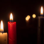 Three Candles On A Black Background