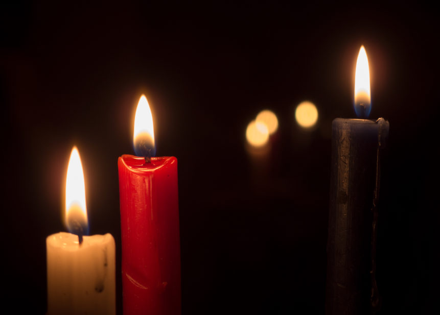 Three Candles On A Black Background