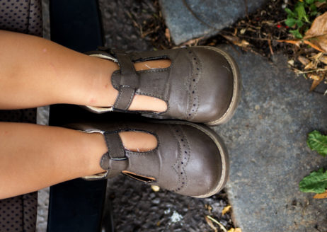 Legs and Shoes of a Little Baby in a Stroller Legs and Shoes of a Little Baby in a Stroller