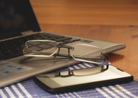 Glasses, Laptop And Phone On The Office Desk Glasses, Laptop And Phone On The Office Desk