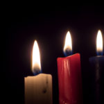 Three candles on a black background