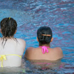Two women sitting in a swimming pool Two women sitting in a swimming pool