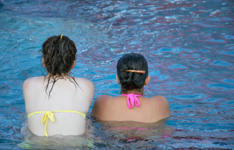 Two women sitting in a swimming pool Two women sitting in a swimming pool