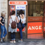 Three young women and ATM Three young women and atm