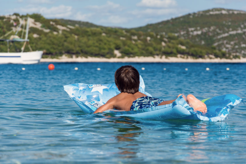 children on inflatable sunbed