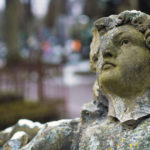 broken statue in a cemetery