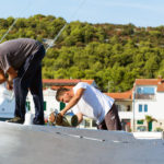 Two Workers Are Repairing a Boat Two workers are repairing the ship