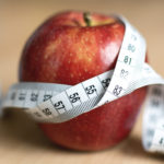 Diet Concept - Red Apple And Tape Measure Diet concept - Red apple and tape measure