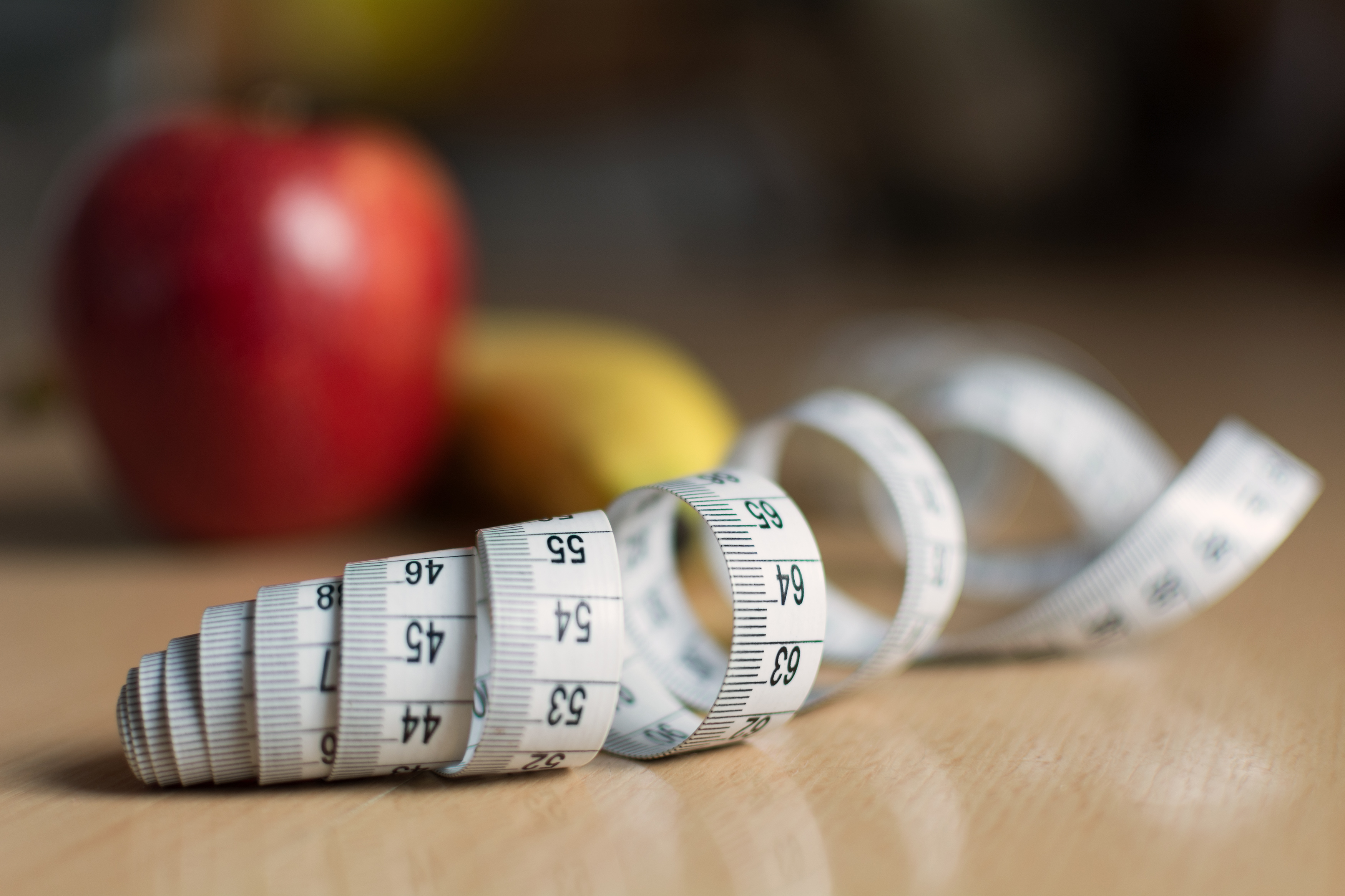 Stock photo of apple and measuring tape