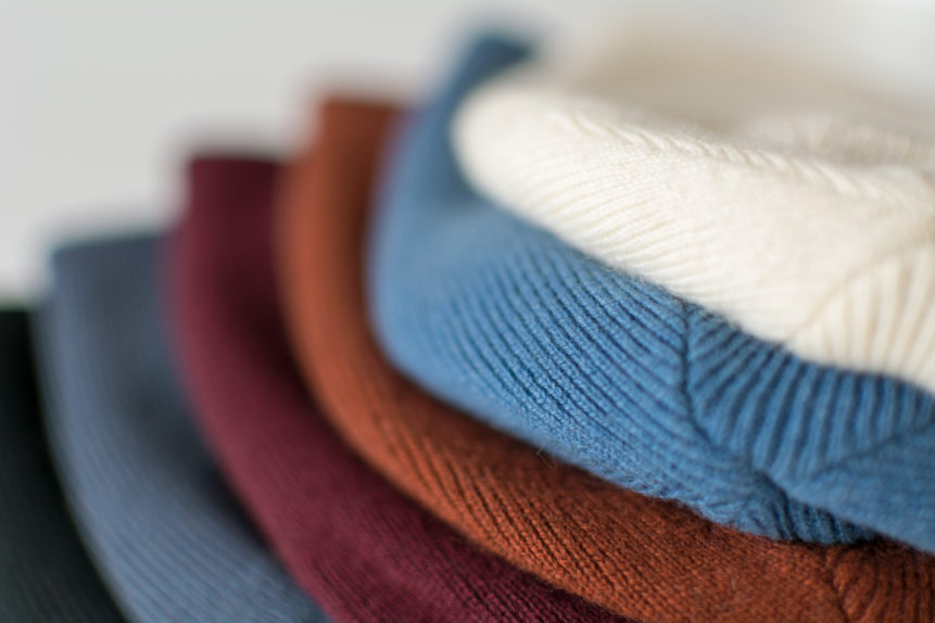 Luxury woolen caps in various colors folded in shop