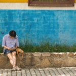 Young woman sitting with phone on the street Young woman sitting with phone on the street