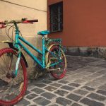 Old bright colored bicycle on the old street Old bright colored bicycle on the old street