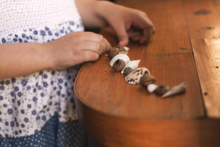 Child Playing with Seashells
