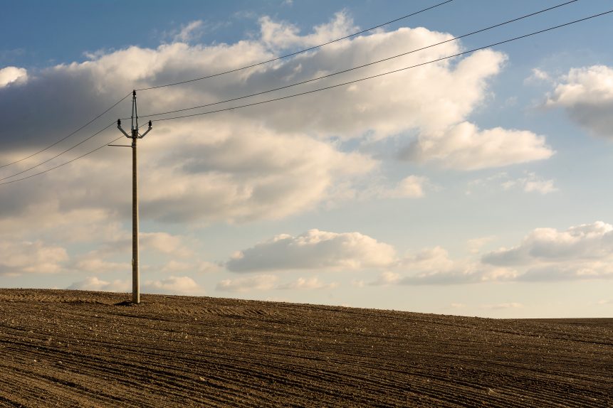 Electric pole in brown fields