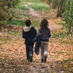 Children Walking Away on the Forest Path