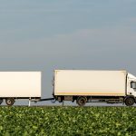 A white Truck with Trailer White truck with trailer driving along the road