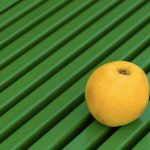 Yellow Apple on a Green Background Yellow apple on green background