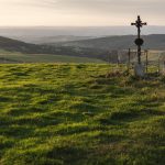Cross on the green meadow