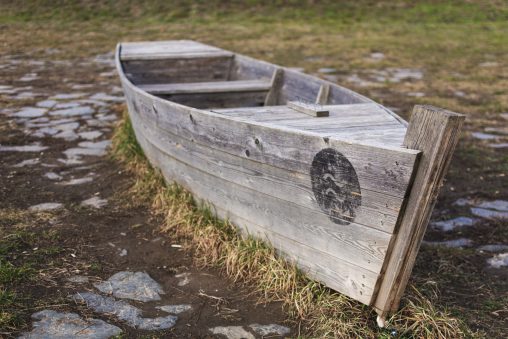 Abandoned Wooden Boat on Land