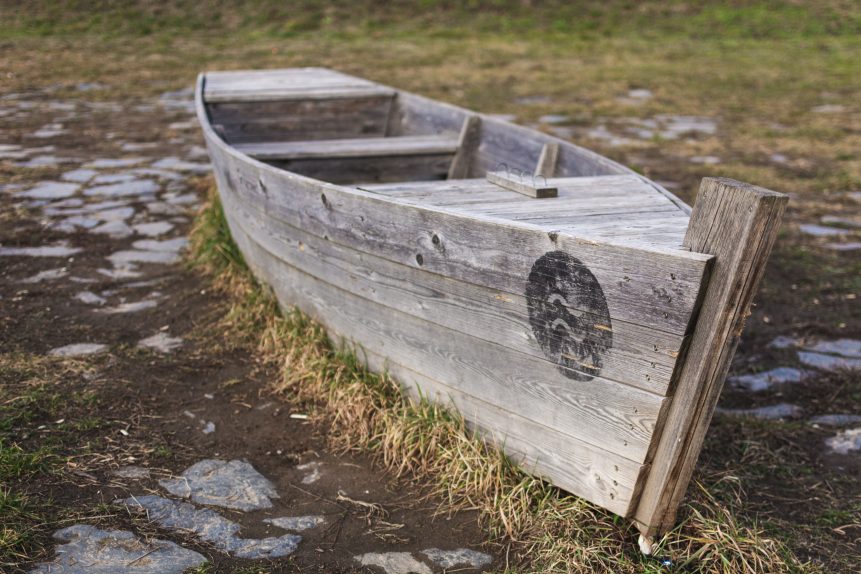Abandoned wooden boat on land