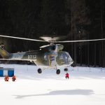 A Military Helicopter Lands in the Snow A military helicopter lands in the snow