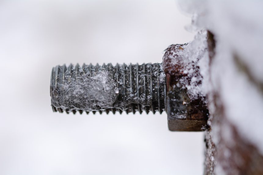 Frozen screw with nut - free stock photo